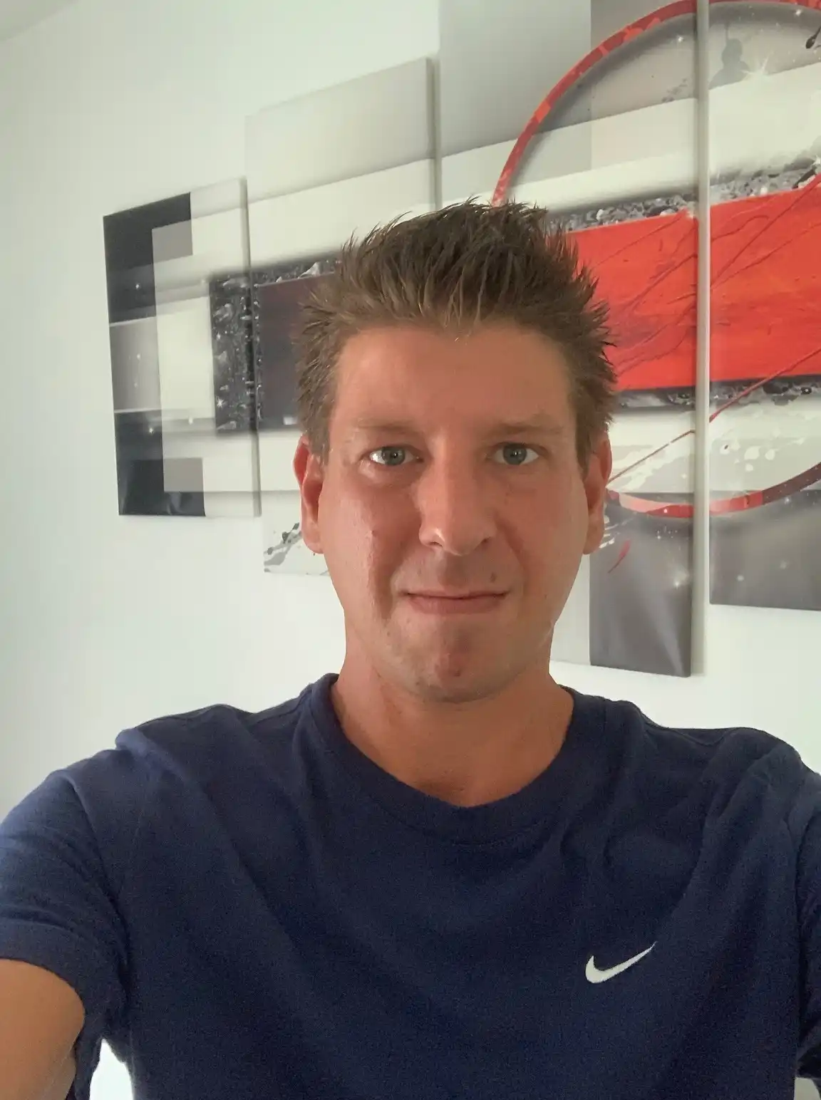 A middle-aged man with glasses in a yellow and blue striped shirt. This persona represents a satisfied homeowner in Barnsley, South Yorkshire, after a loft timber audit.