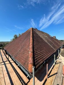 Newly completed roof with terracotta tiles and scaffolding on residential property in Lincolnshire
