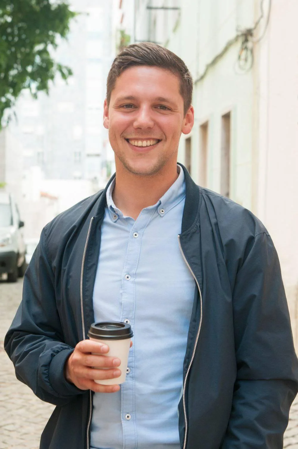 A professional man in a blue suit and tie with arms crossed. This represents a satisfied homeowner in Sheffield, South Yorkshire, after a successful mortgage-compliant spray foam removal.
