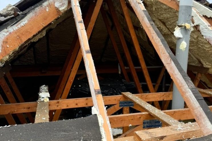 Spray foam insulation removal in East Sussex, showing exposed roof rafters and timber structure after foam extraction, professional roof restoration service