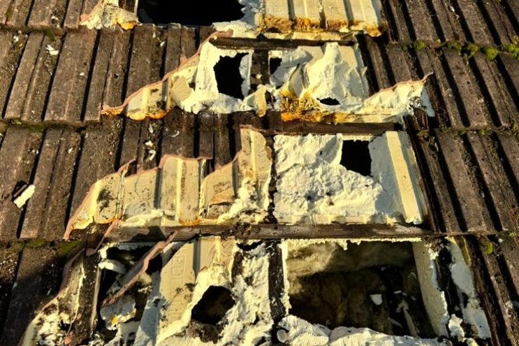 Spray foam insulation removal in Lancashire showing damaged roof tiles and exposed insulation, professional extraction and roof restoration service