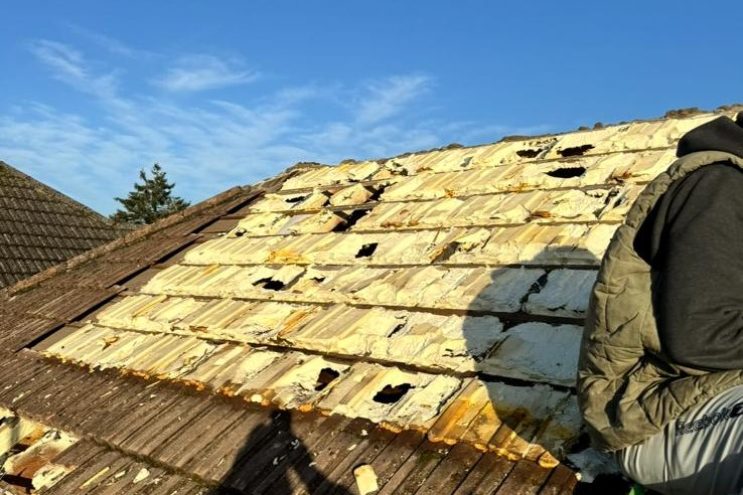 Spray foam insulation removal in Leicestershire, roofer extracting old foam from roof tiles and rafters, professional restoration service