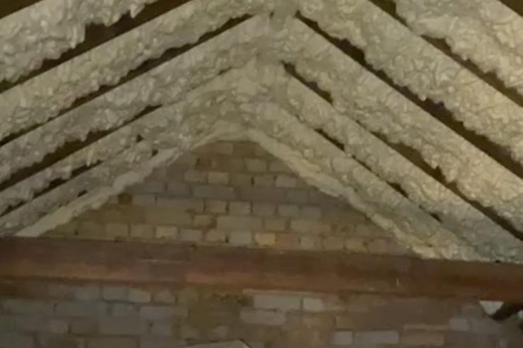 Spray foam insulation removal in South Yorkshire, showing foam applied to roof rafters and loft structure requiring professional extraction service