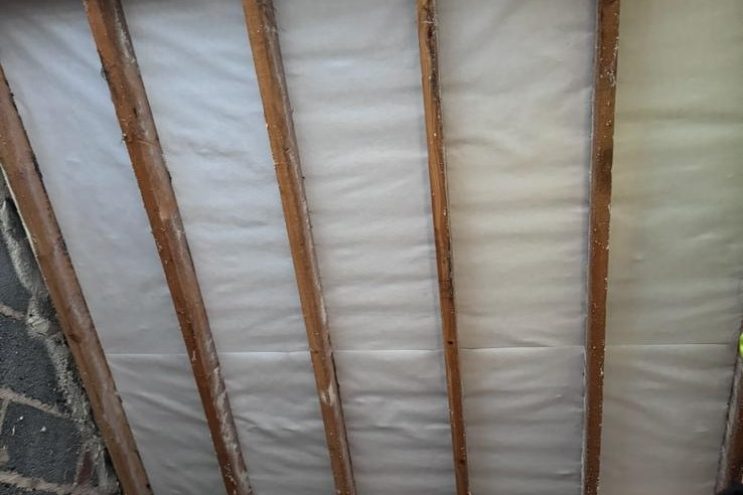 Spray foam insulation removal in Tyne and Wear showing timber roof rafters and insulation membrane, professional loft clearance and roof restoration service