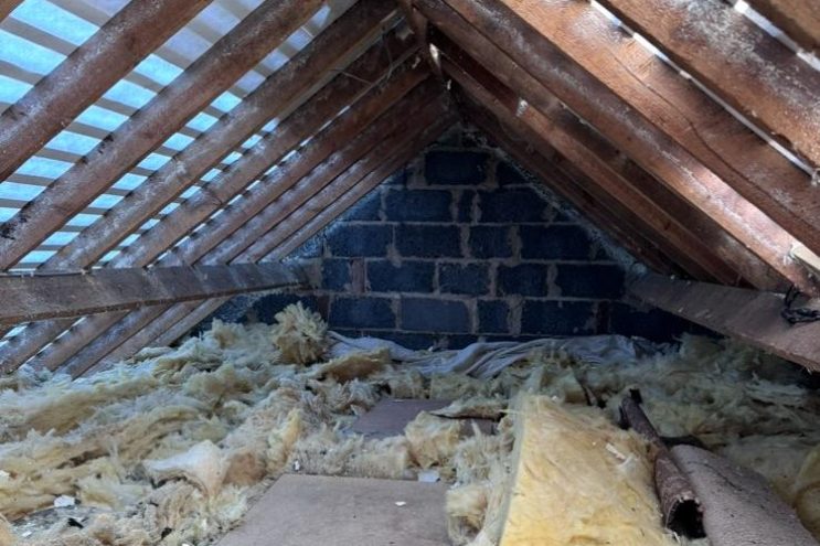 Spray foam insulation removal in Warwickshire showing timber roof rafters and loft insulation clearance, professional attic restoration service