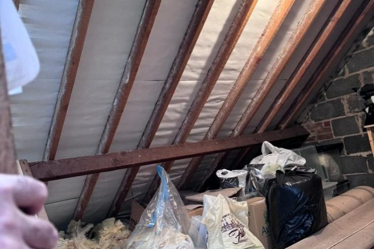 Spray foam insulation removal in West Midlands showing timber roof rafters and loft clearance, professional attic restoration and insulation extraction service